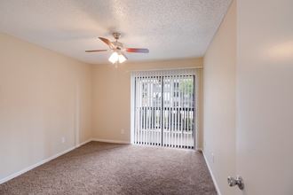 Empty living room with a ceiling fan and a window at The Glen at Highpoint, Dallas, TX, 75243
