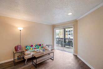 Living room with a couch and a tableat The Glen at Highpoint, Dallas, TX, 75243