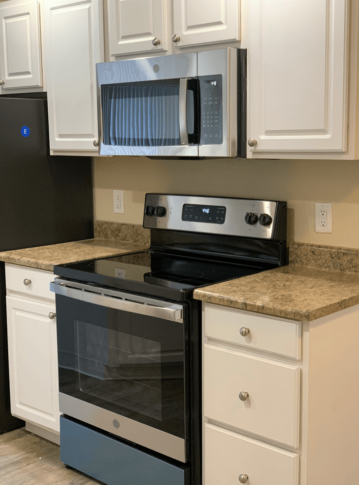 Kitchen with White Cabinets and Black Appliances at Arcadia Townhomes, Federal Way, WA, 98023