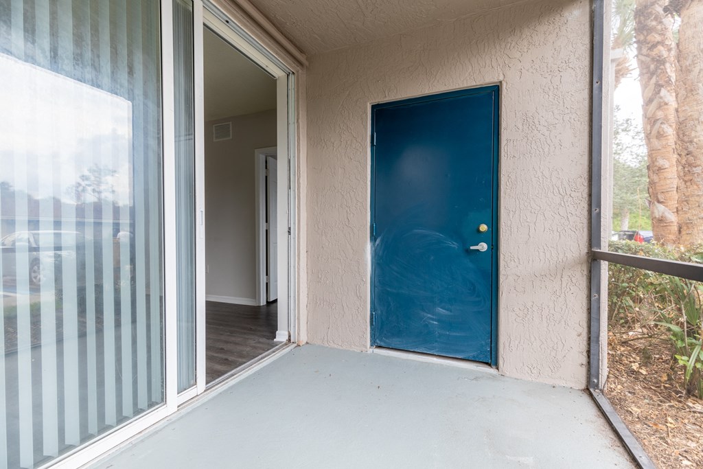 a porch with a blue door at the whispering winds apartments in pearland, tx at Heritage Bay, Jensen Beach, 34957