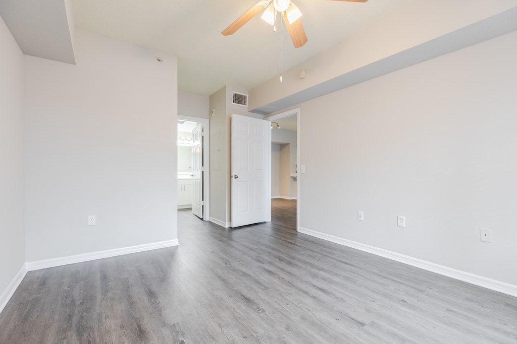 a bedroom with hardwood floors and white walls at Heritage Bay, Florida, 34957