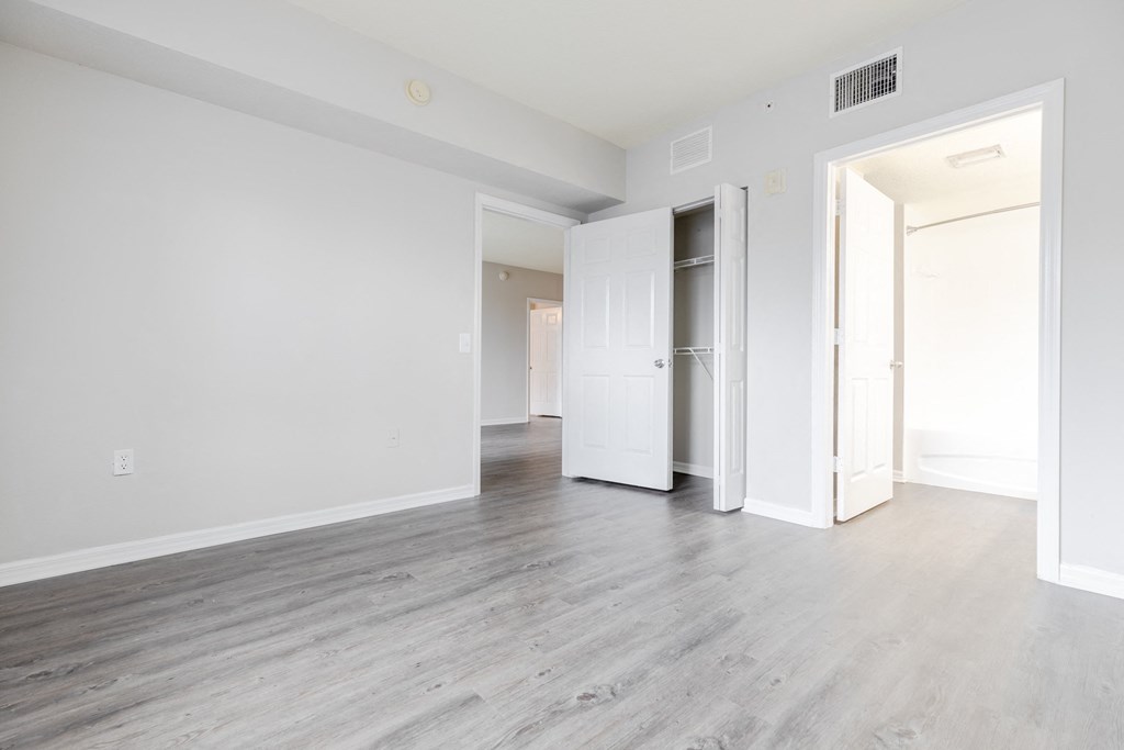 a bedroom with hardwood floors and white walls at Heritage Bay, Florida