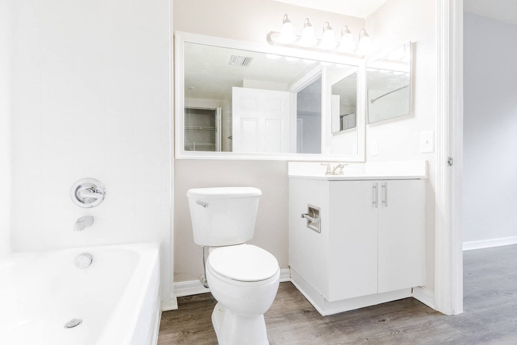 a bathroom with a white sink and toilet and a white bathtub at Heritage Bay, Florida