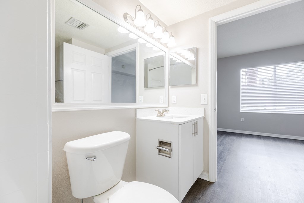 a bathroom with a toilet sink and mirror at Heritage Bay, Jensen Beach, 34957