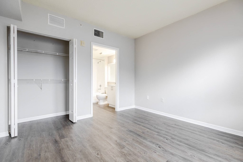 a bedroom with a medium sized bed and a closet with a sliding door at Heritage Bay, Jensen Beach, 34957