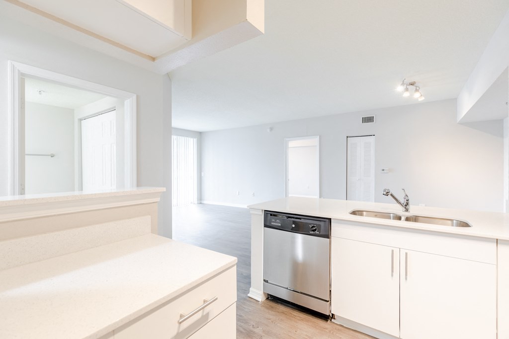 a kitchen with white cabinets and a stainless steel dishwasher at Heritage Bay, Jensen Beach Florida