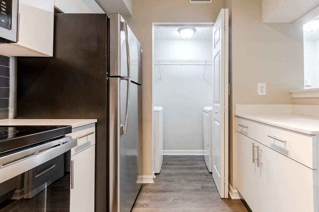 a kitchen with white cabinets and stainless steel appliances at Heritage Bay, Jensen Beach, FL 34957
