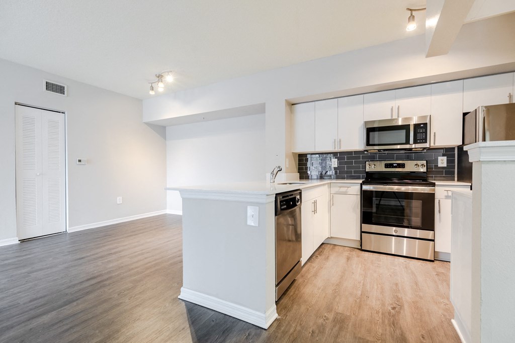 a kitchen with white cabinetry and stainless steel appliances at Heritage Bay, Jensen Beach Florida
