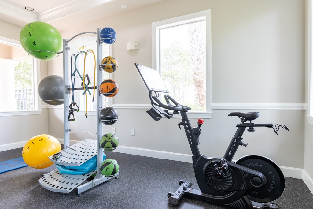 a home gym with an exercise bike and weights at Heritage Bay, Jensen Beach, 34957