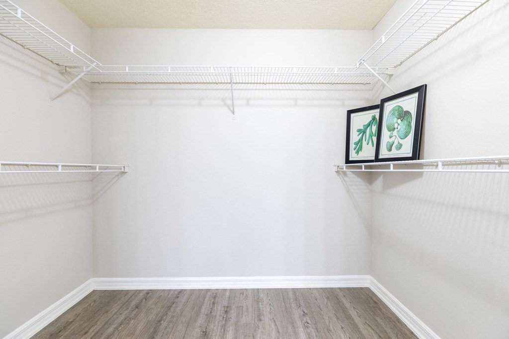 an empty closet with white walls and white shelves at Heritage Bay, Jensen Beach, 34957