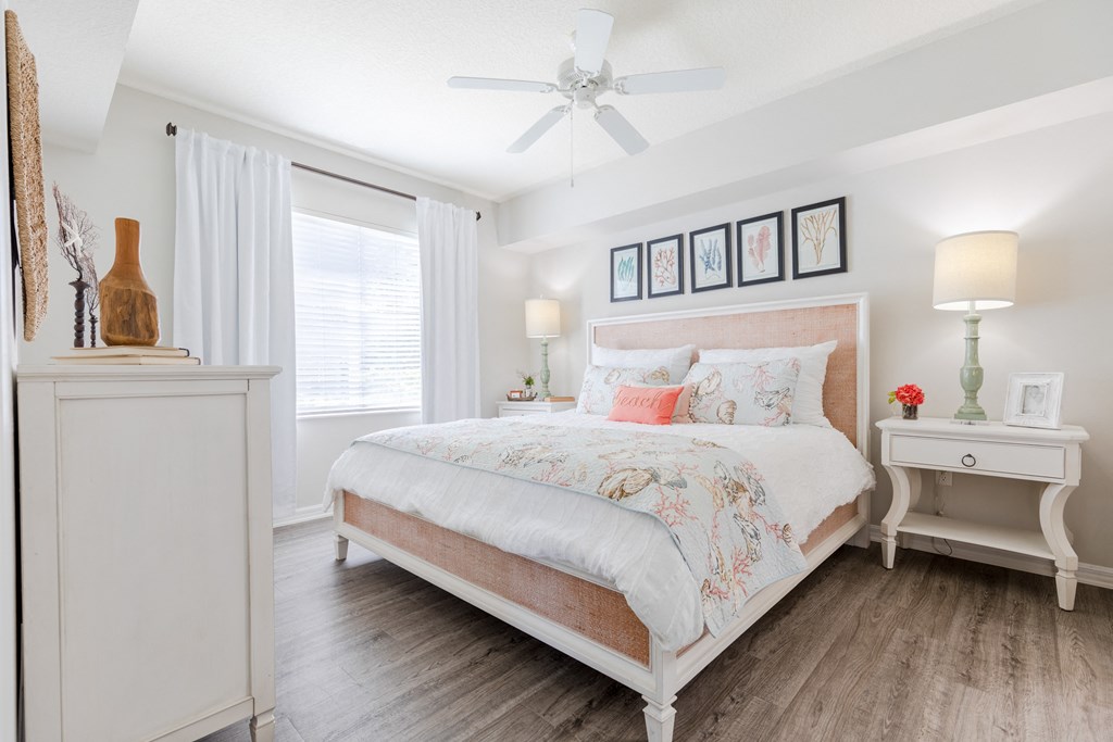 a bedroom with a bed and two nightstands at Heritage Bay, Florida