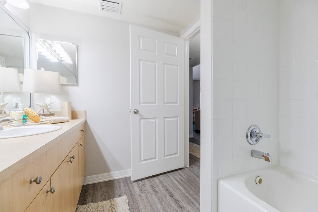 a bathroom with a bathtub and a sink at Heritage Bay, Jensen Beach, FL