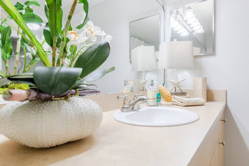 a bathroom with a sink and a mirror at Heritage Bay, Jensen Beach, FL