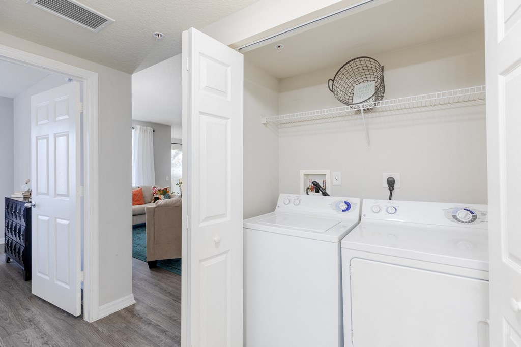 a washer and dryer in a room with a living room in the background at Heritage Bay, Jensen Beach Florida