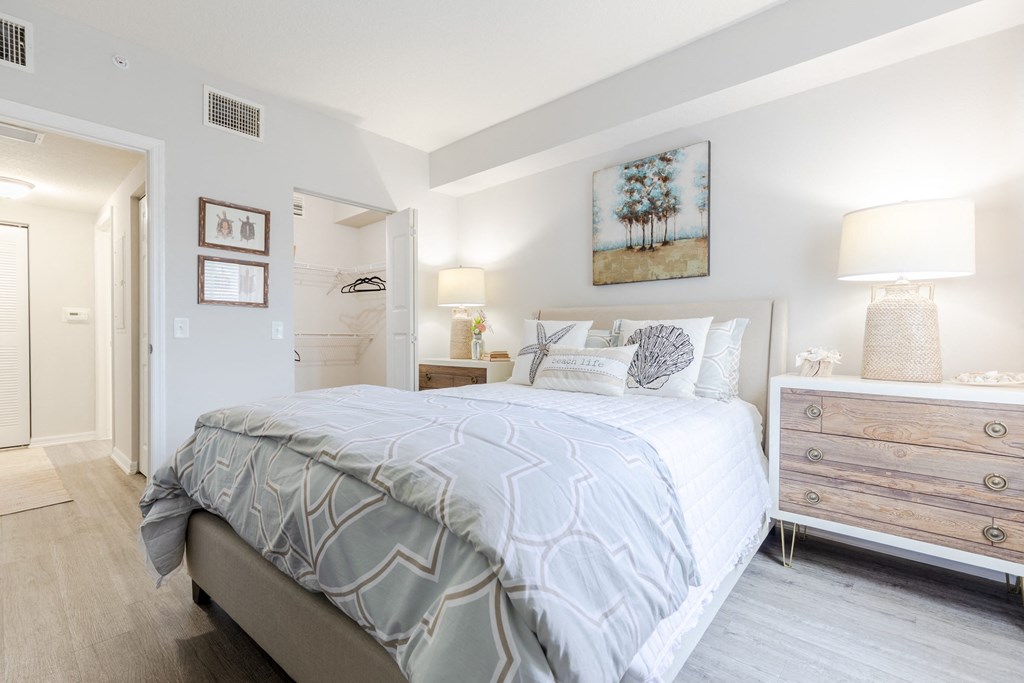 a bedroom with a bed and a dresser with a mirror at Heritage Bay, Jensen Beach Florida