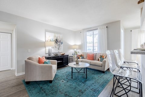 a living room with white walls and a turquoise rug at Heritage Bay, Florida, 34957