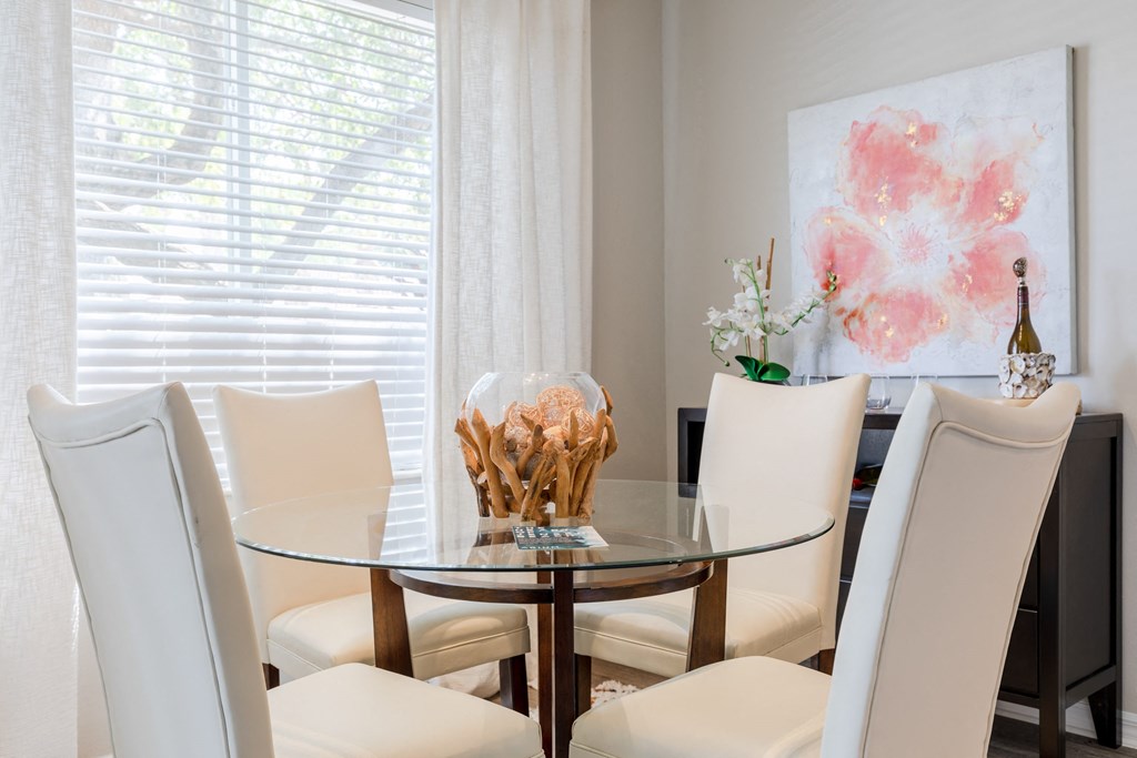 a dining room with a glass table and white chairs at Heritage Bay, Florida, 34957