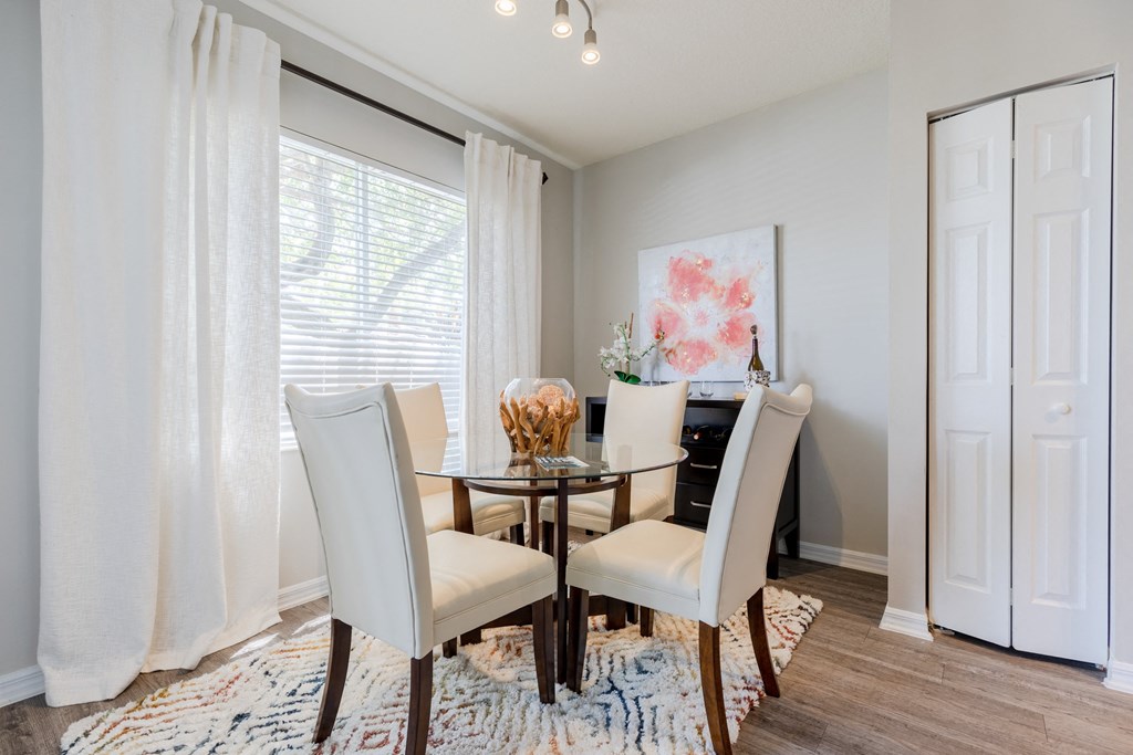 a dining room with a table and chairs at Heritage Bay, Jensen Beach Florida