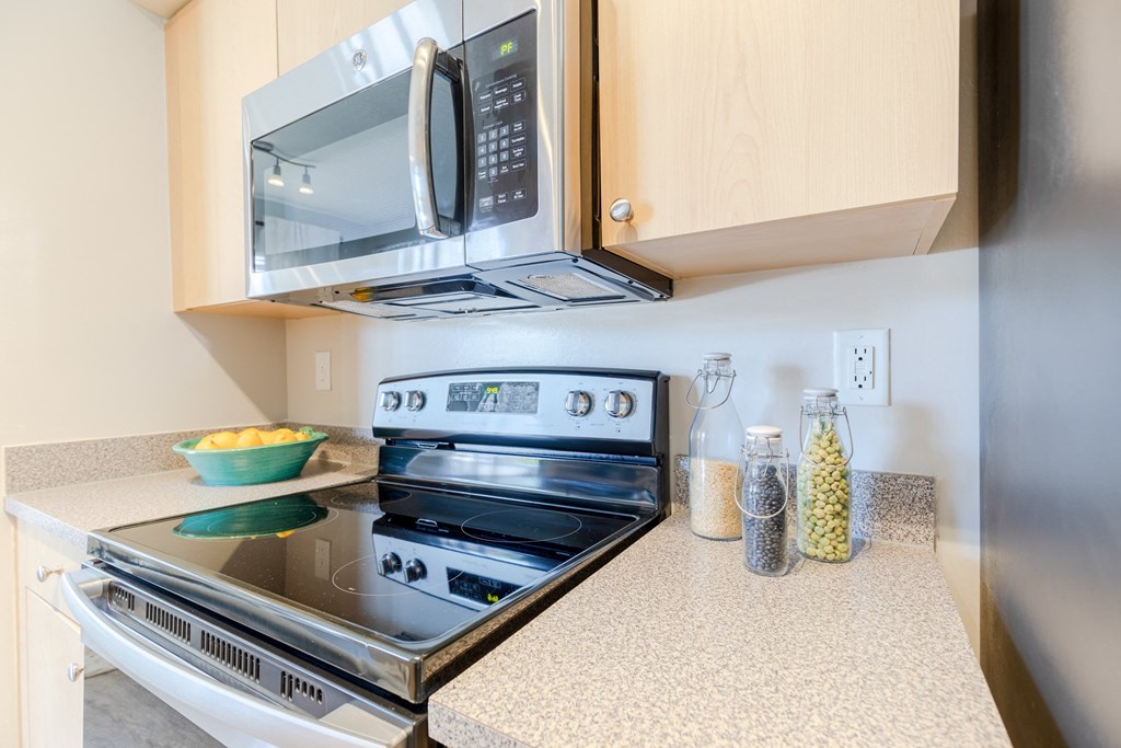 a kitchen with a stove and microwave in a 555 waverly unit at Heritage Bay, Jensen Beach, FL 34957