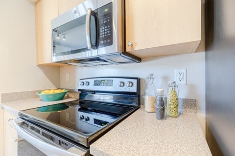 a kitchen with a stove and microwave in a 555 waverly unit at Heritage Bay, Jensen Beach, FL 34957