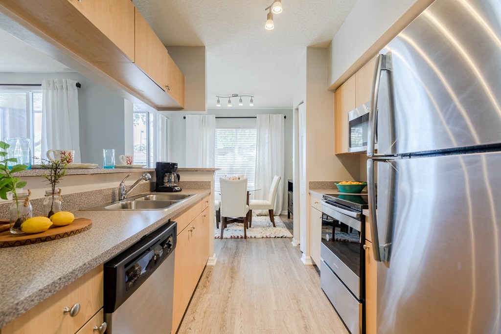 a kitchen with wooden cabinets and stainless steel appliances at Heritage Bay, Jensen Beach, FL 34957