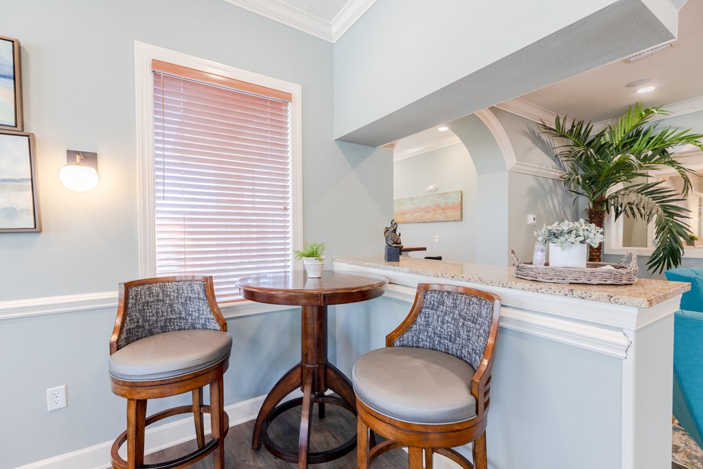 a bar area with two stools and a window at Heritage Bay, Florida