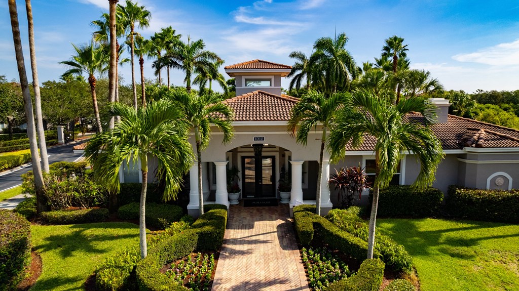 a house with palm trees in front of it at Heritage Bay, Jensen Beach, FL 34957