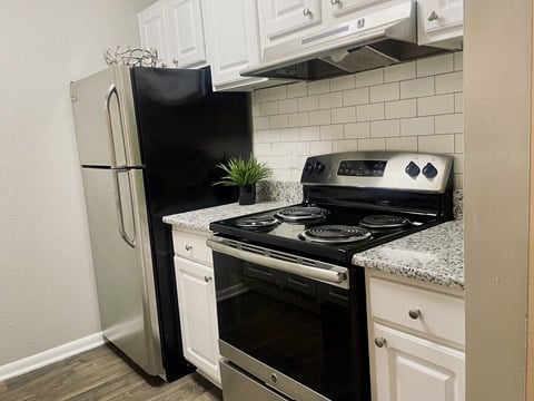 Upgraded kitchen with a stove and a refrigerator at The Pointe at Irving Park, Greensboro, NC, 27408