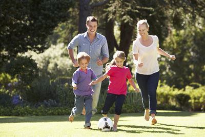 Family playing Soccer Outside Image