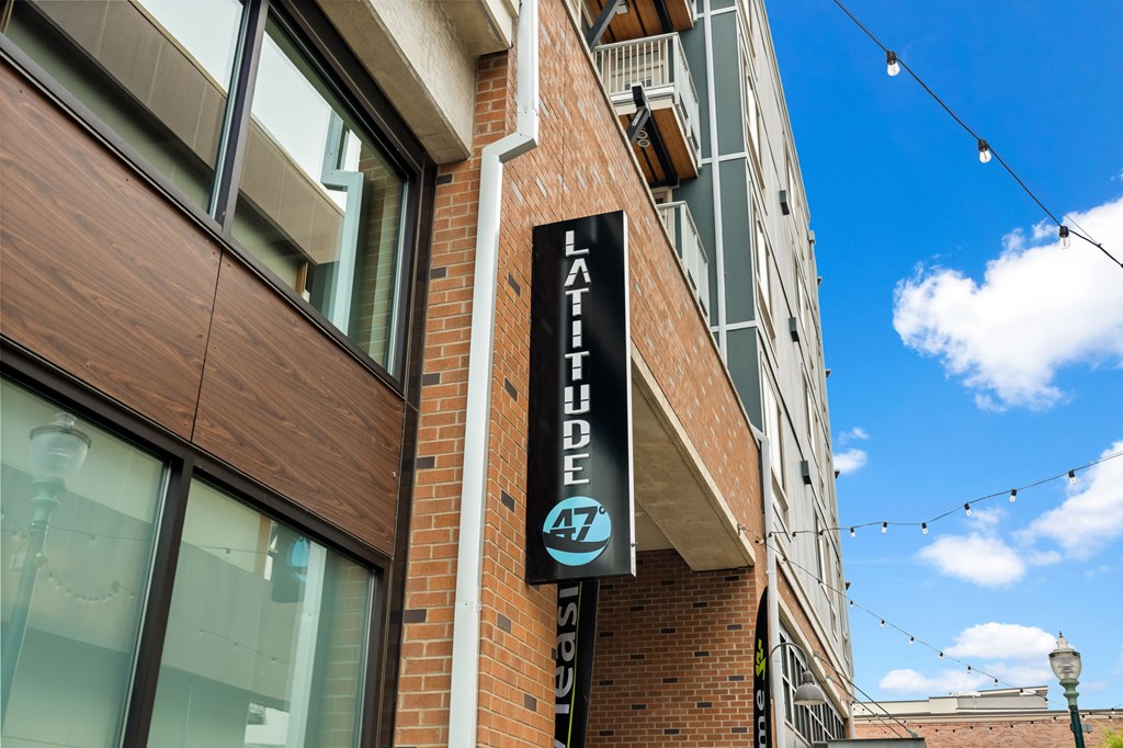 A sign on a building that says Latitude 47.