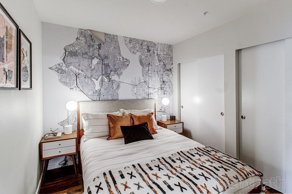 a bedroom with a bed and a map on the wall