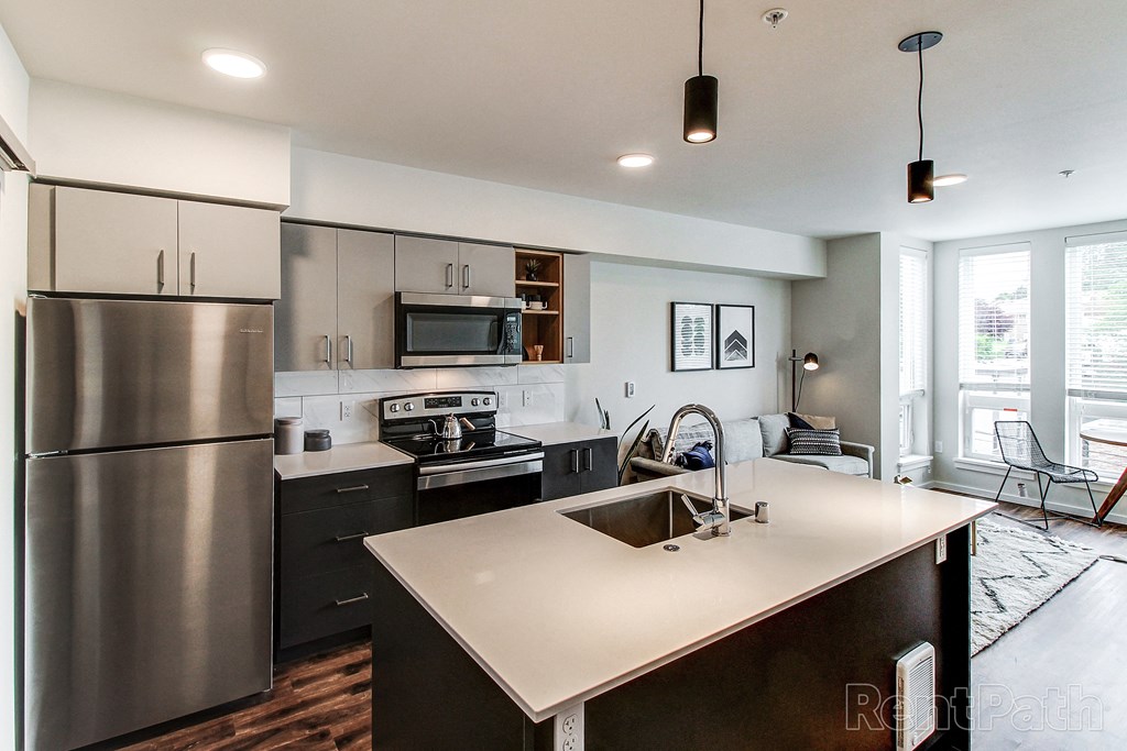 a kitchen with stainless steel appliances and a white counter top