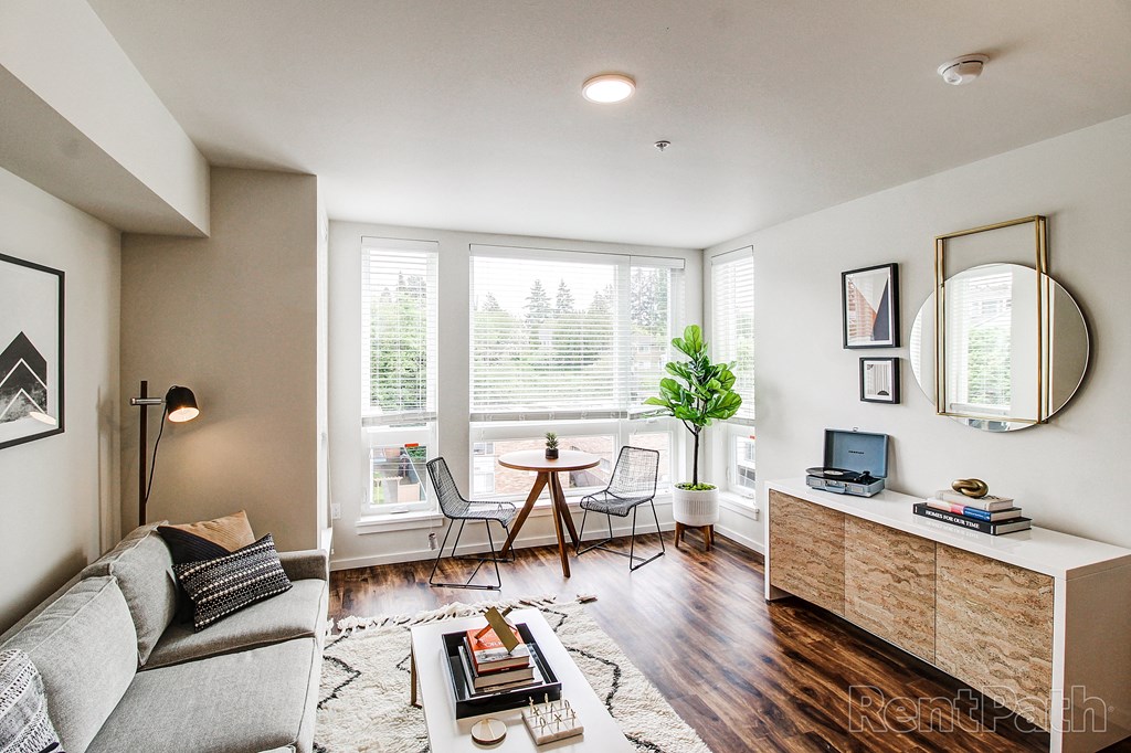 a living room with a couch and a table with two chairs