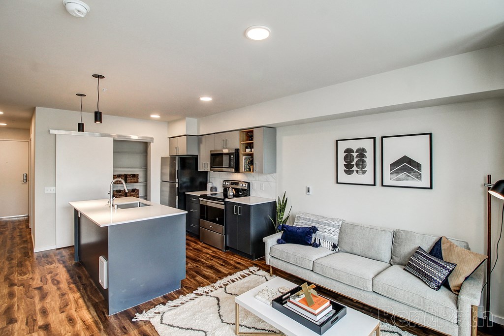 a living room with a kitchen and a couch