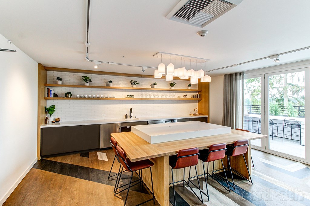 a kitchen with a wooden table and chairs and a sink