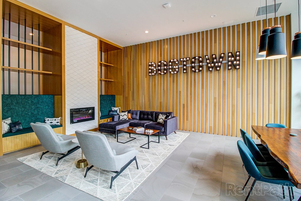 a living room with a couch chairs and a table and a fireplace