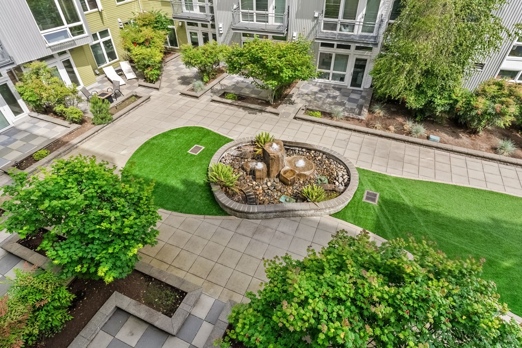 A courtyard with a fountain surrounded by buildings.