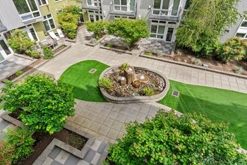 A courtyard with a fountain surrounded by buildings.