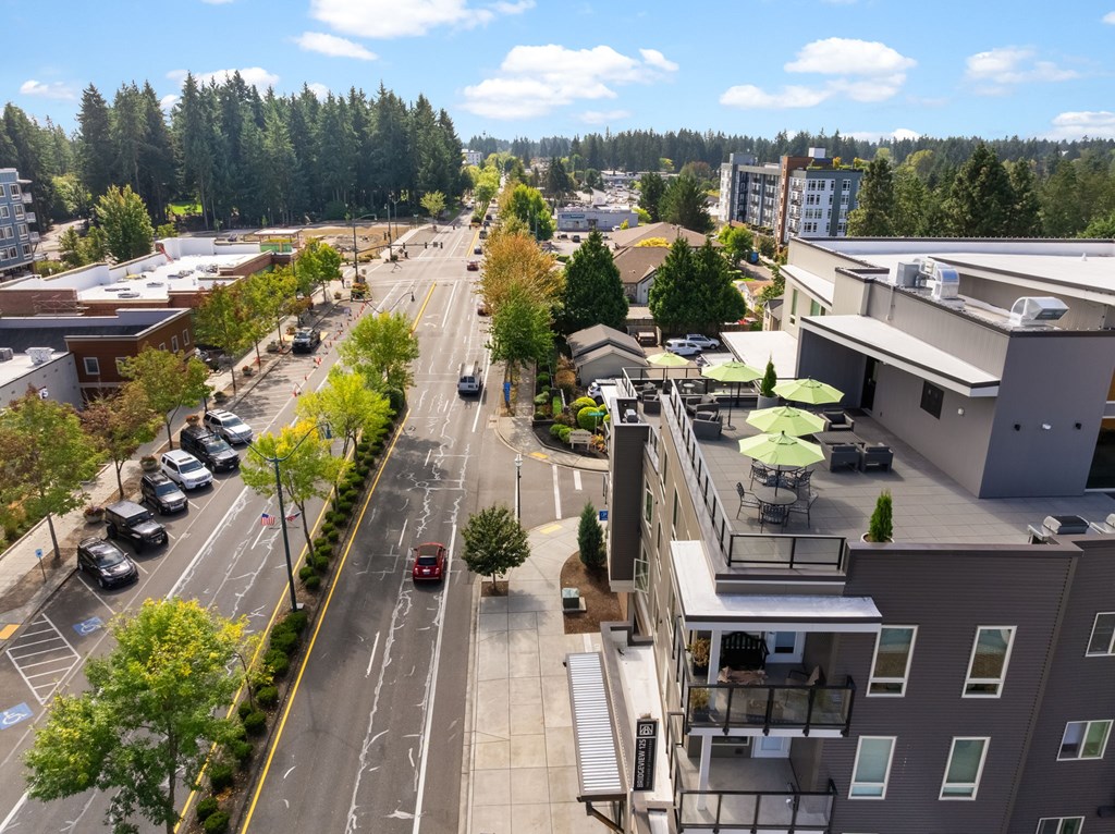 A street view of a city with cars parked on the side of the road.