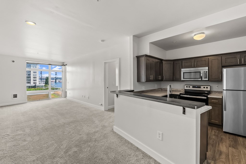 A kitchen with a white countertop and stainless steel appliances.