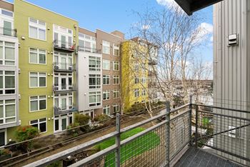 A view of a green and yellow building from a balcony.