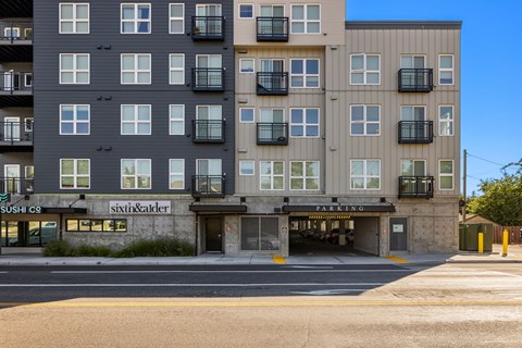 A multi-story building with a sushi restaurant on the ground floor.