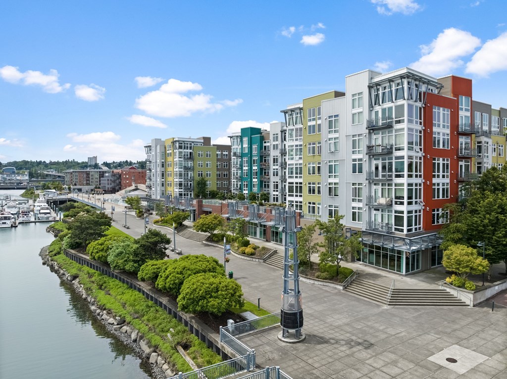 A view of a city with buildings and a body of water.