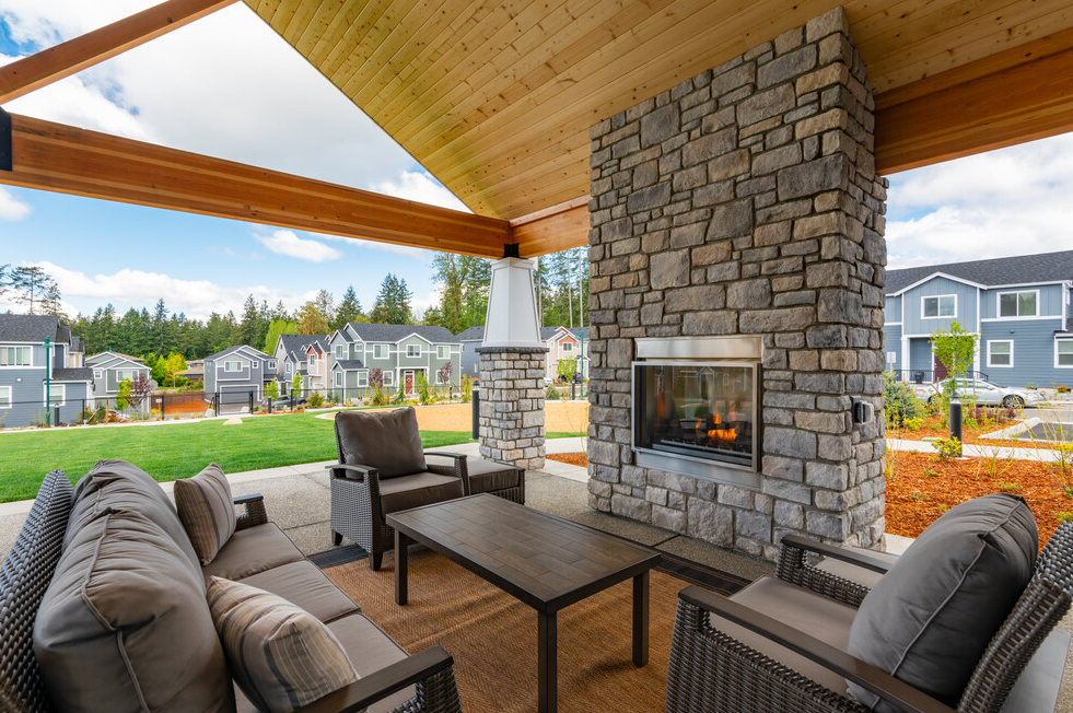 the pavilion outdoor living area with fireplace and couches