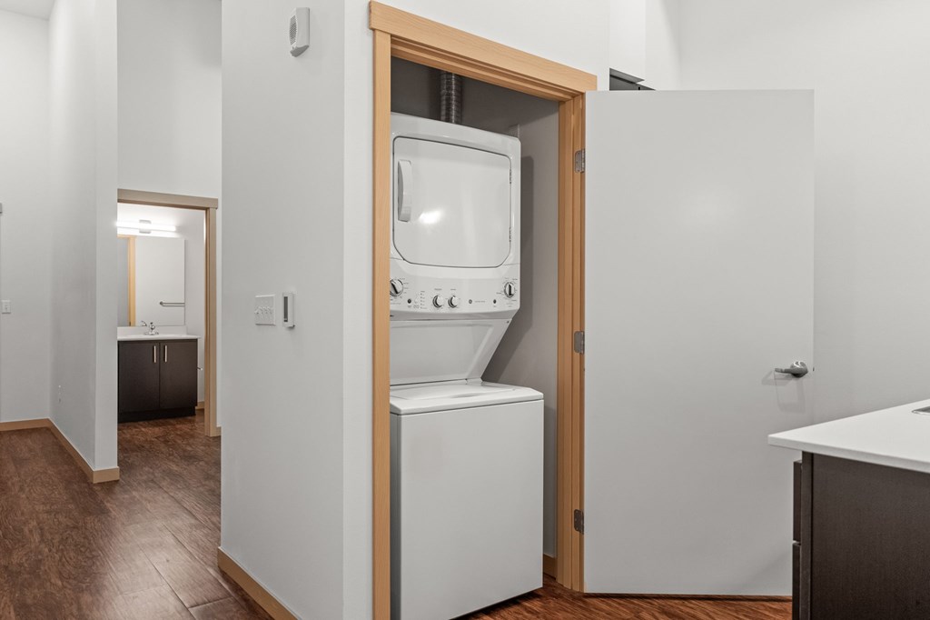 A white oven is built into a wall in a kitchen.