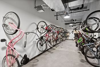 A bike rack with many bikes hanging on it.