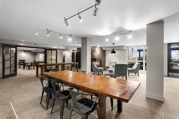 A conference room with a long table and chairs.