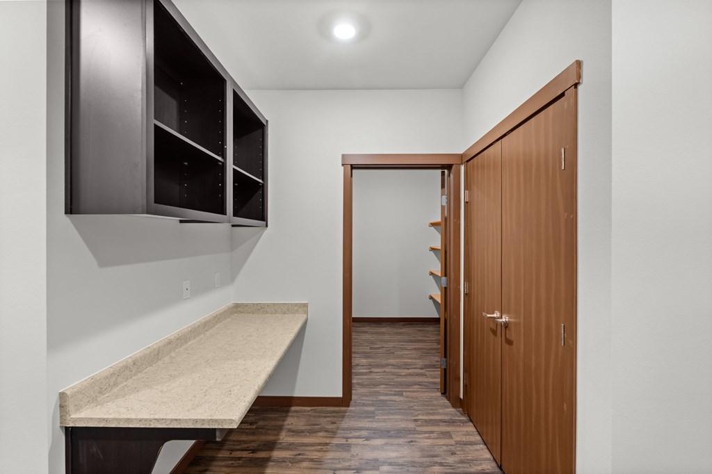 A kitchen with a bench and a wooden door.