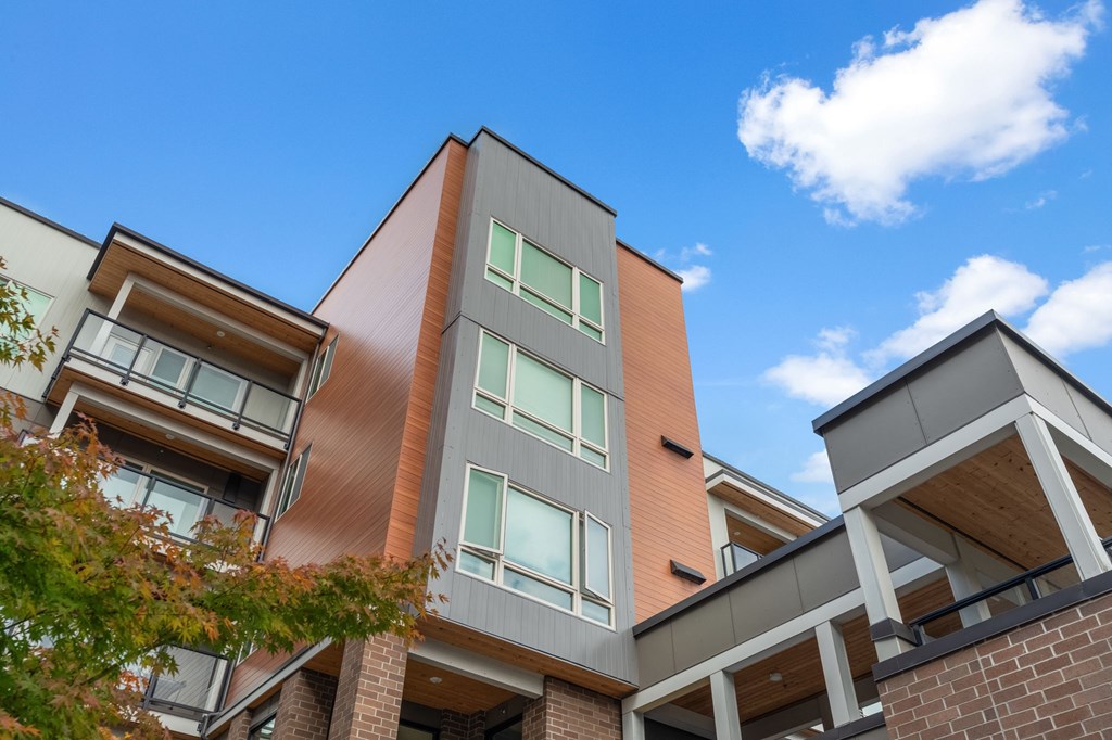 A modern building with a mix of brown and grey tones.