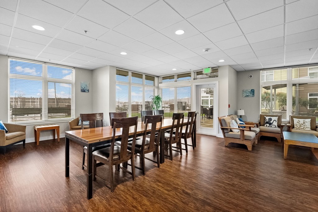 A room with wooden floors and furniture.